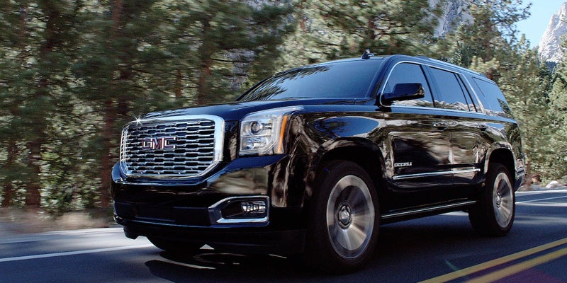 black GMC Yukon running on road