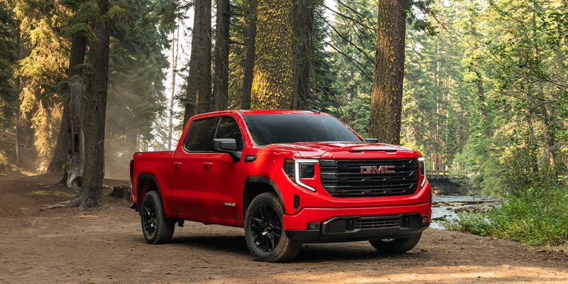 2026 GMC Sierra 1500 parked in forest showcasing rugged performance near Ozark, AL